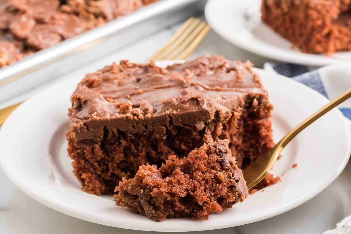 A individual serving of cake on a white plate.