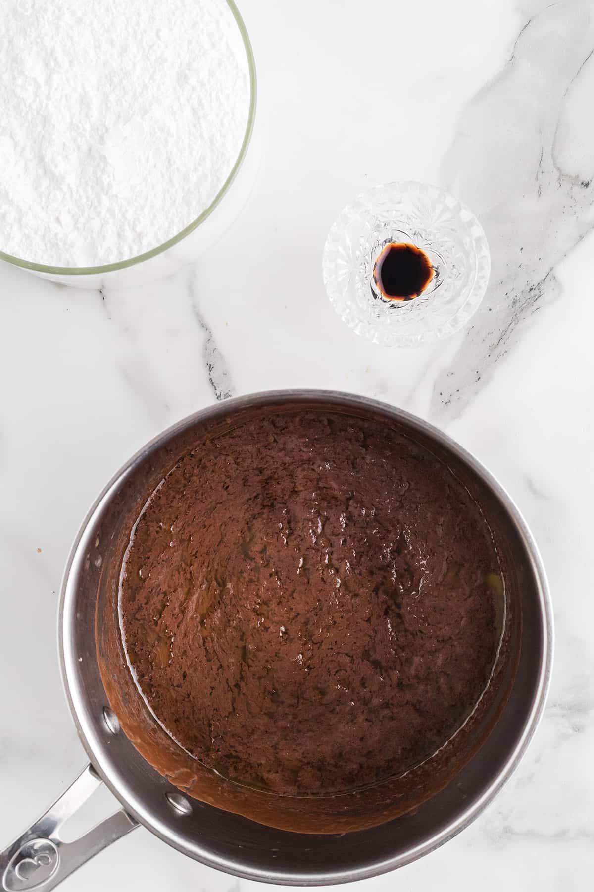 Butter, cocoa, and milk in a saucepan.