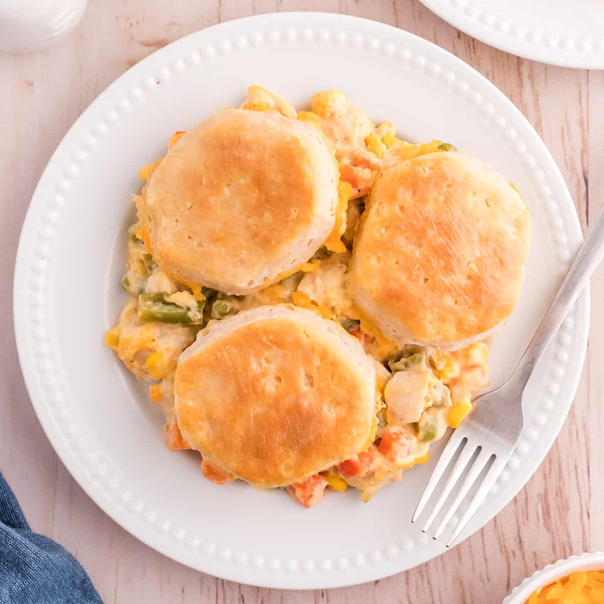 A serving of chicken pot pie casserole on a white plate.