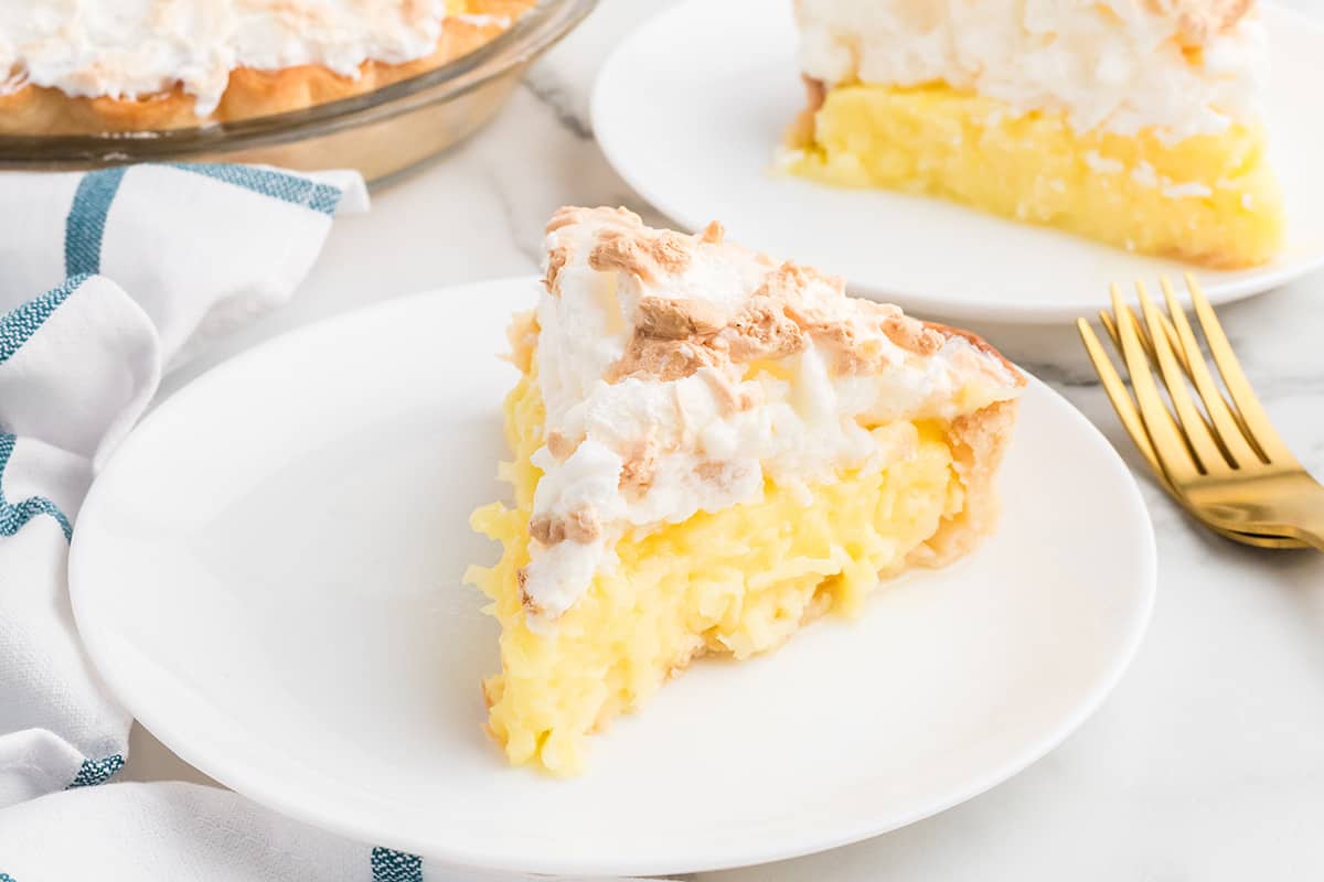 A slice of pie on a white serving plate.