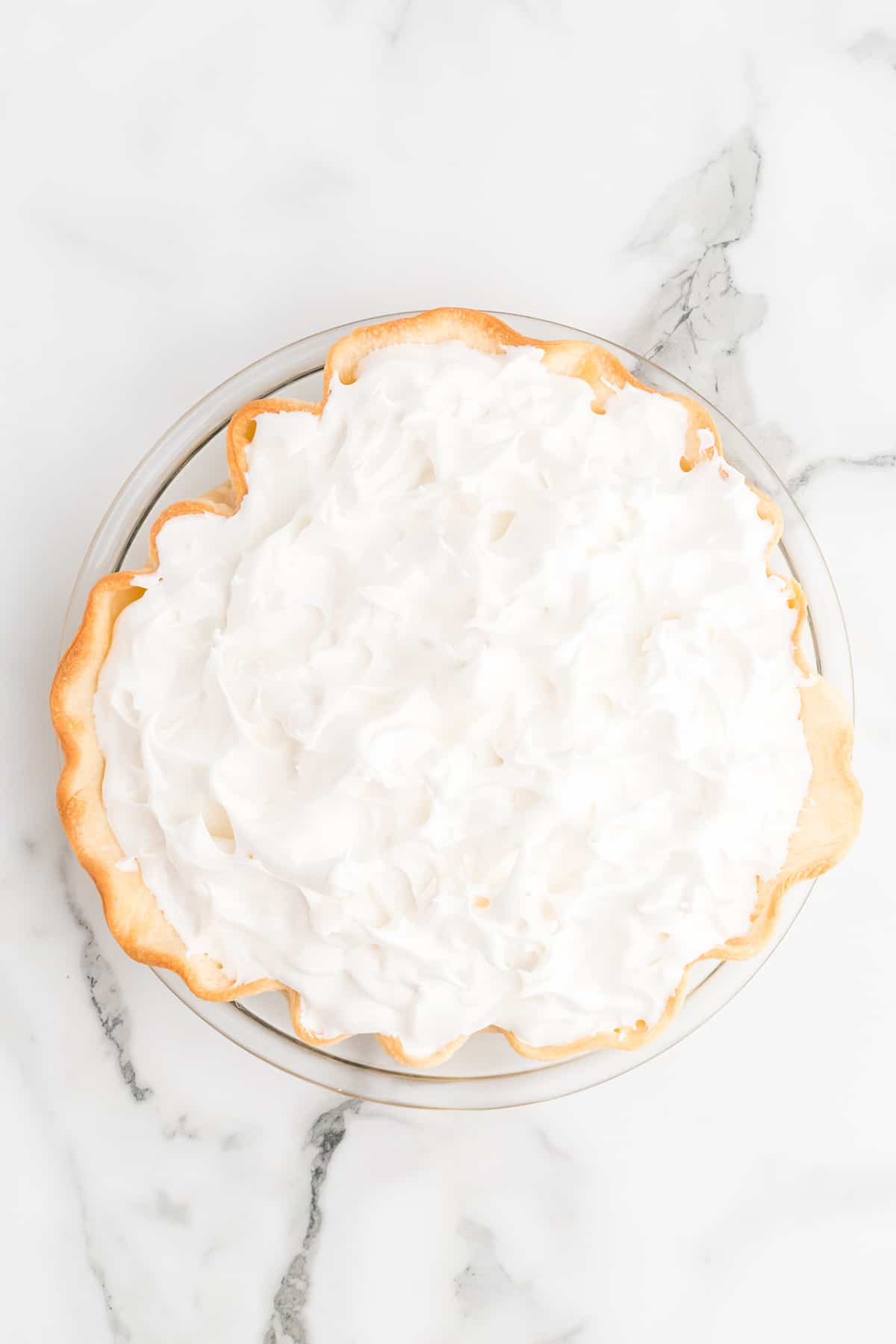 Meringue applied to top of pie.