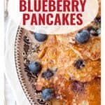Oatmeal blueberry pancakes topped with fresh blueberries on a decorative plate, with website link below.