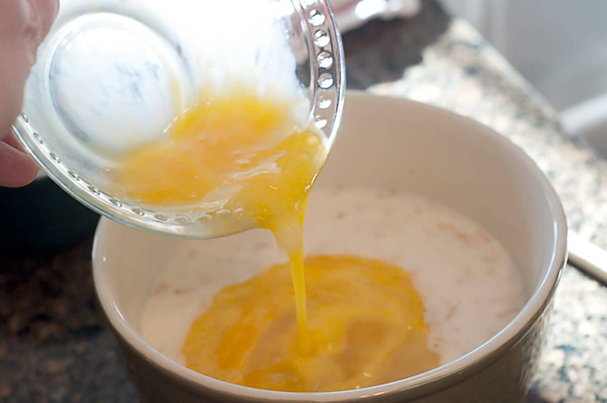 Adding beaten eggs to the mixture.