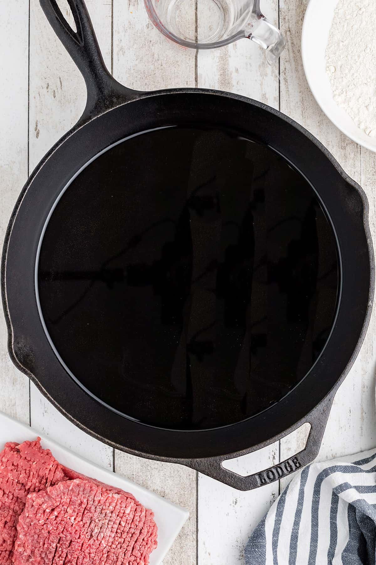 Oil heating in a cast iron skillet.