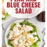 A plate of pear and blue cheese salad with lettuce, almonds, and dressing on a white surface.
