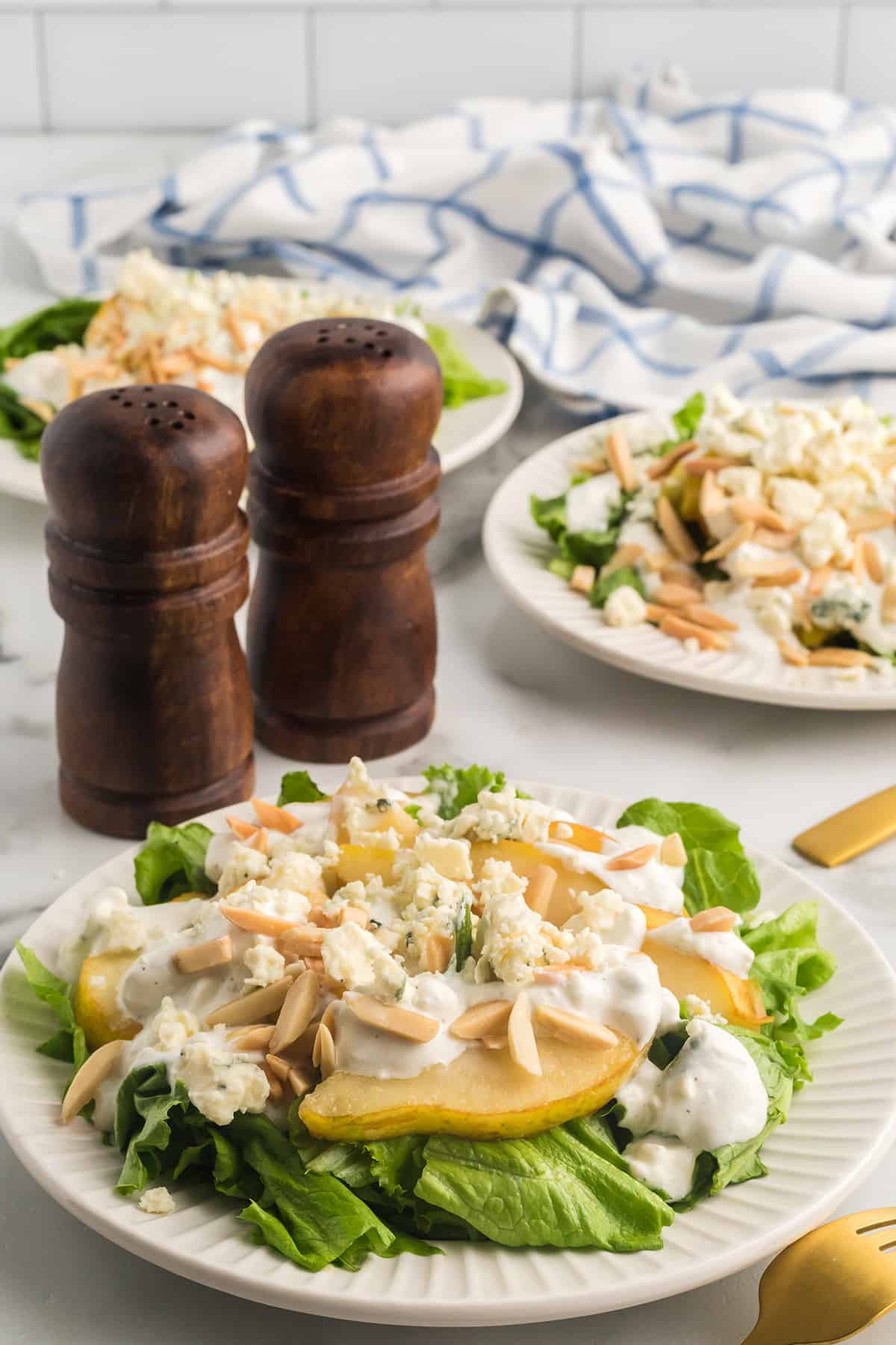 Pear and blue cheese salad on a white serving plate.