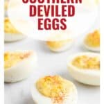 Deviled eggs sprinkled with paprika on a white surface, with text reading Southern Deviled Eggs.