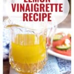 Glass pitcher of yellow lemon vinaigrette beside a salad, with text Lemon Vinaigrette Recipe and a website link.