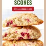 Three raspberry scones stacked on a cooling rack with a website and Raspberry Scones text above.