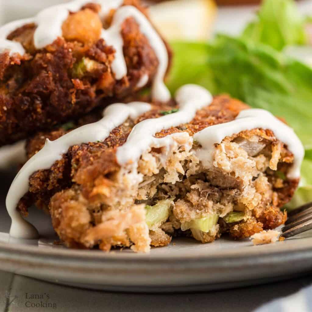 A salmon croquette on a dinner plate.