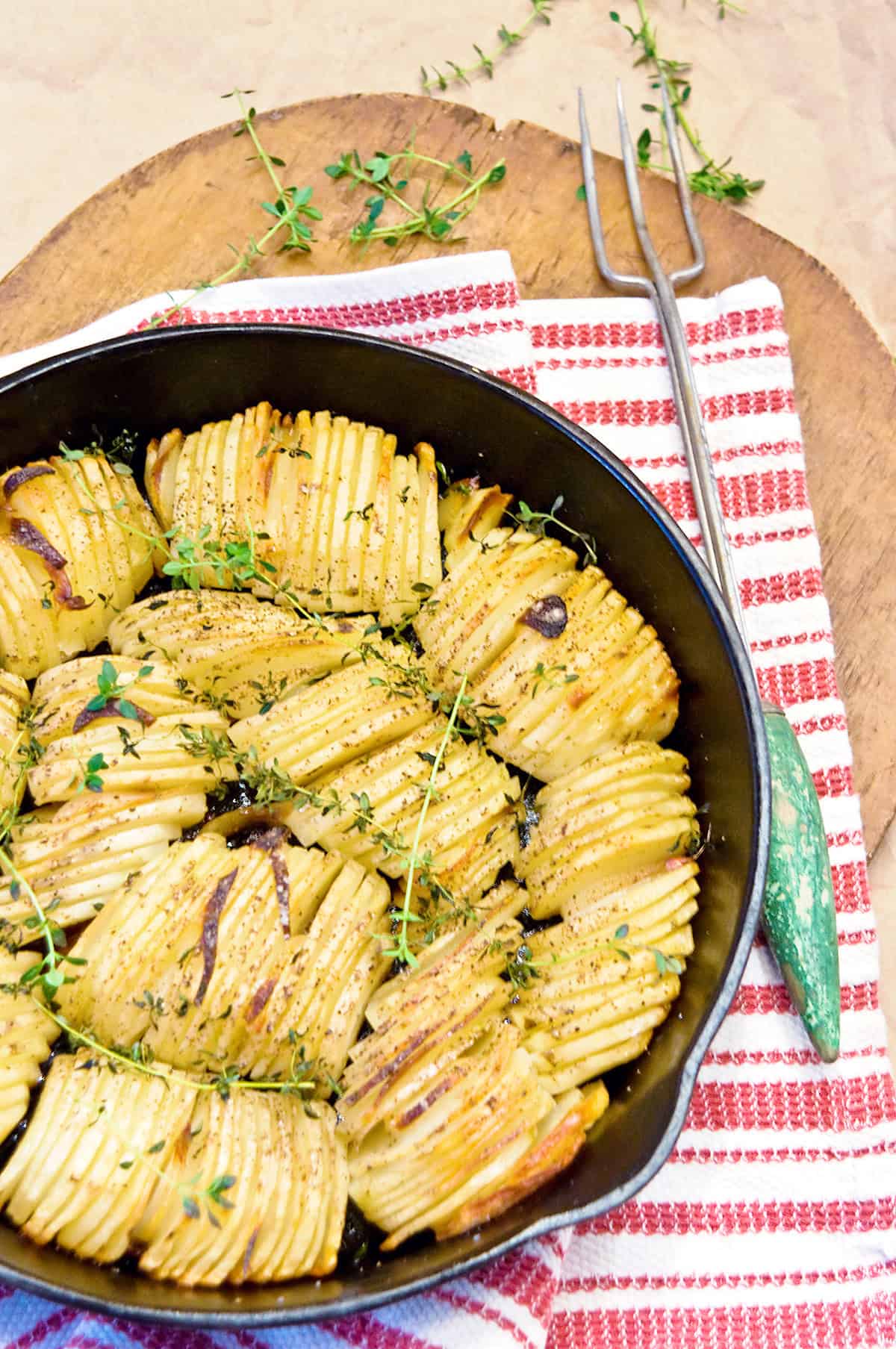 A cast iron skillet filled with cooked, crispy roasted potatoes.