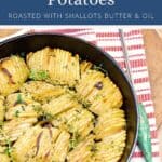 Crispy roasted potatoes with shallots and herbs in a cast iron skillet.