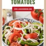 A bowl of sliced tomatoes, onions, and green peppers, seasoned and ready to serve.