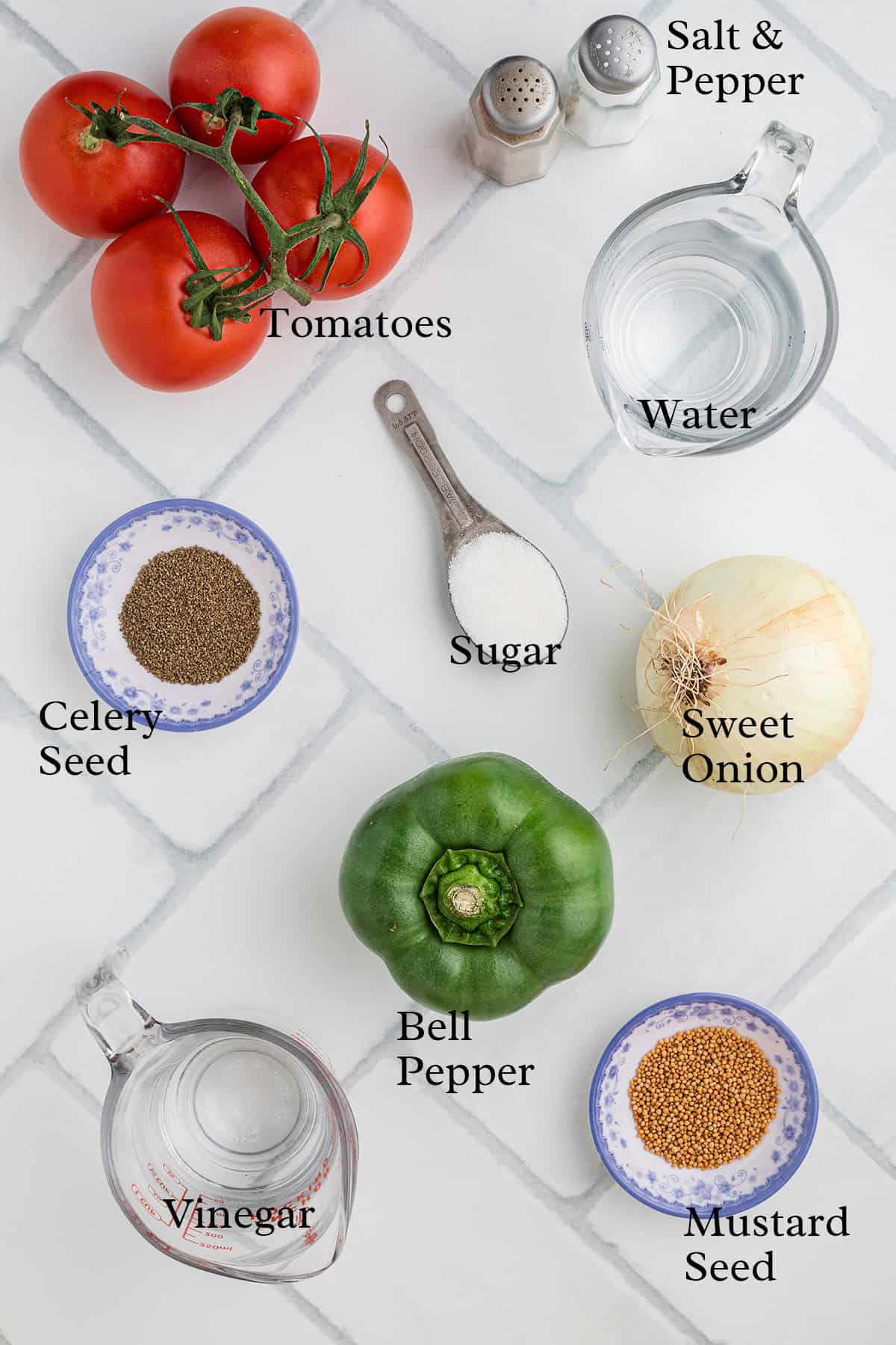 Ingredients for a recipe: tomatoes, onion, bell pepper, vinegar, water, sugar, salt, pepper, celery seed, mustard seed.