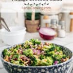 Finished broccoli salad in a blue and white salad bowl.