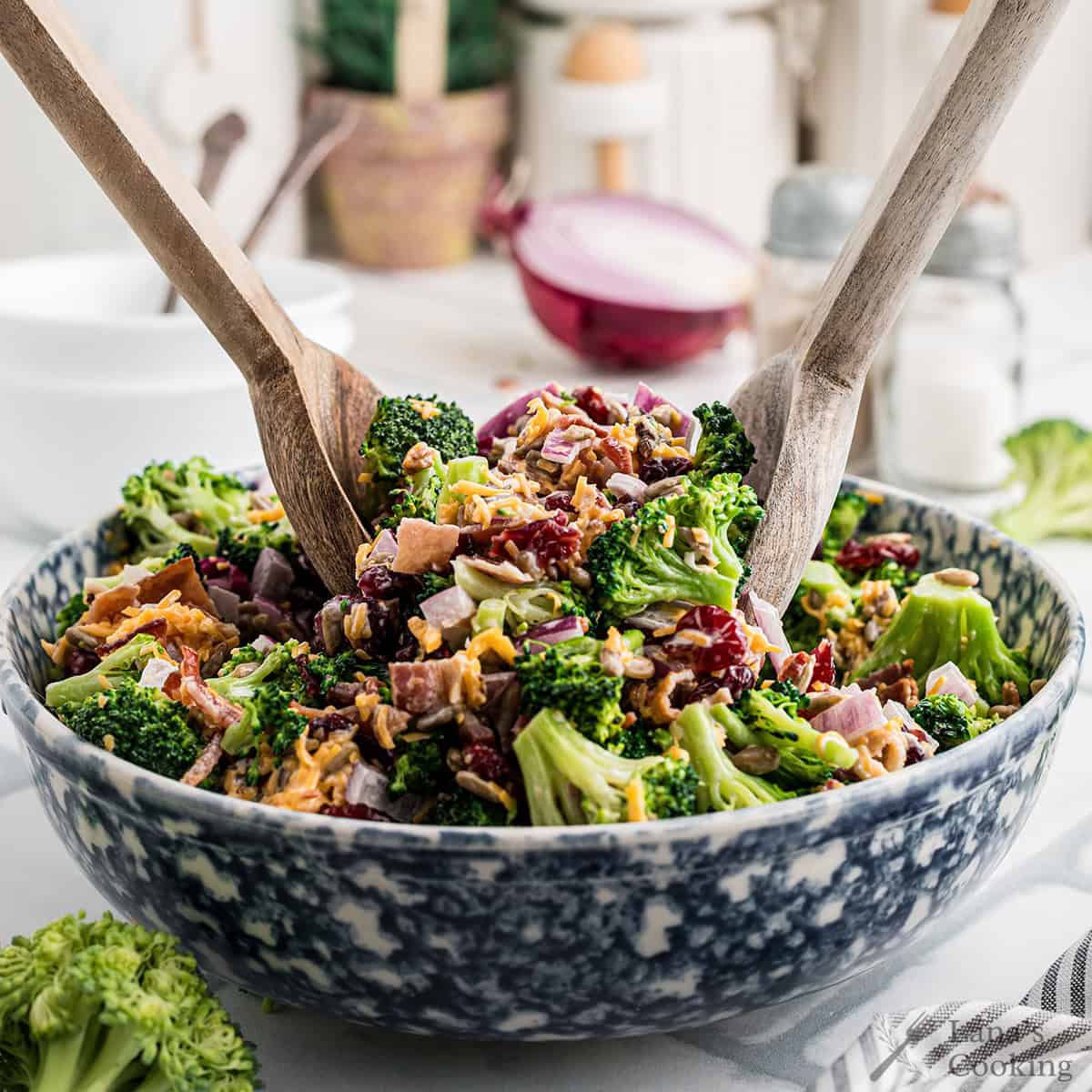 Finished broccoli salad in a blue and white salad bowl.