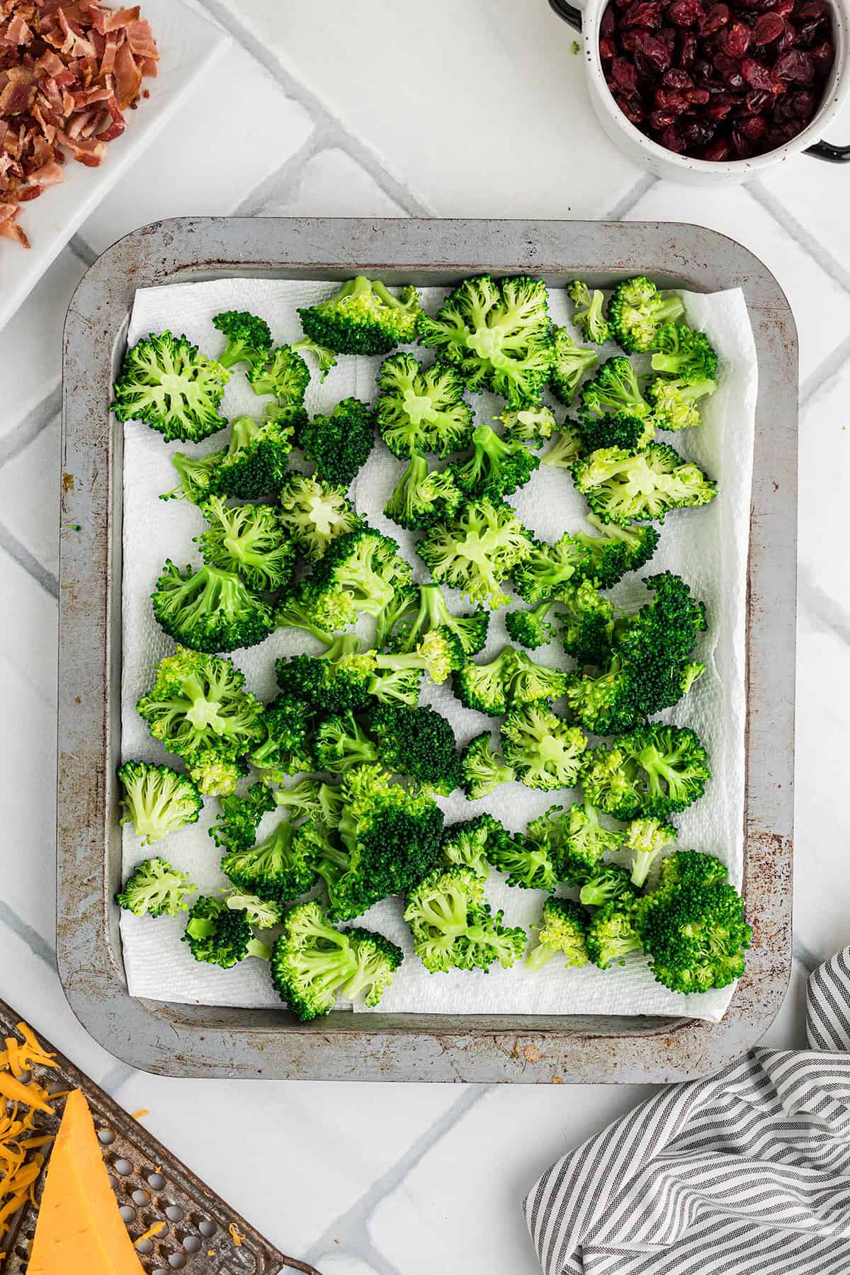 Blanched broccoli draining on paper towels.