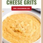 Bowl of creamy southern cheese grits, topped with black pepper, with text “Southern Cheese Grits” above.