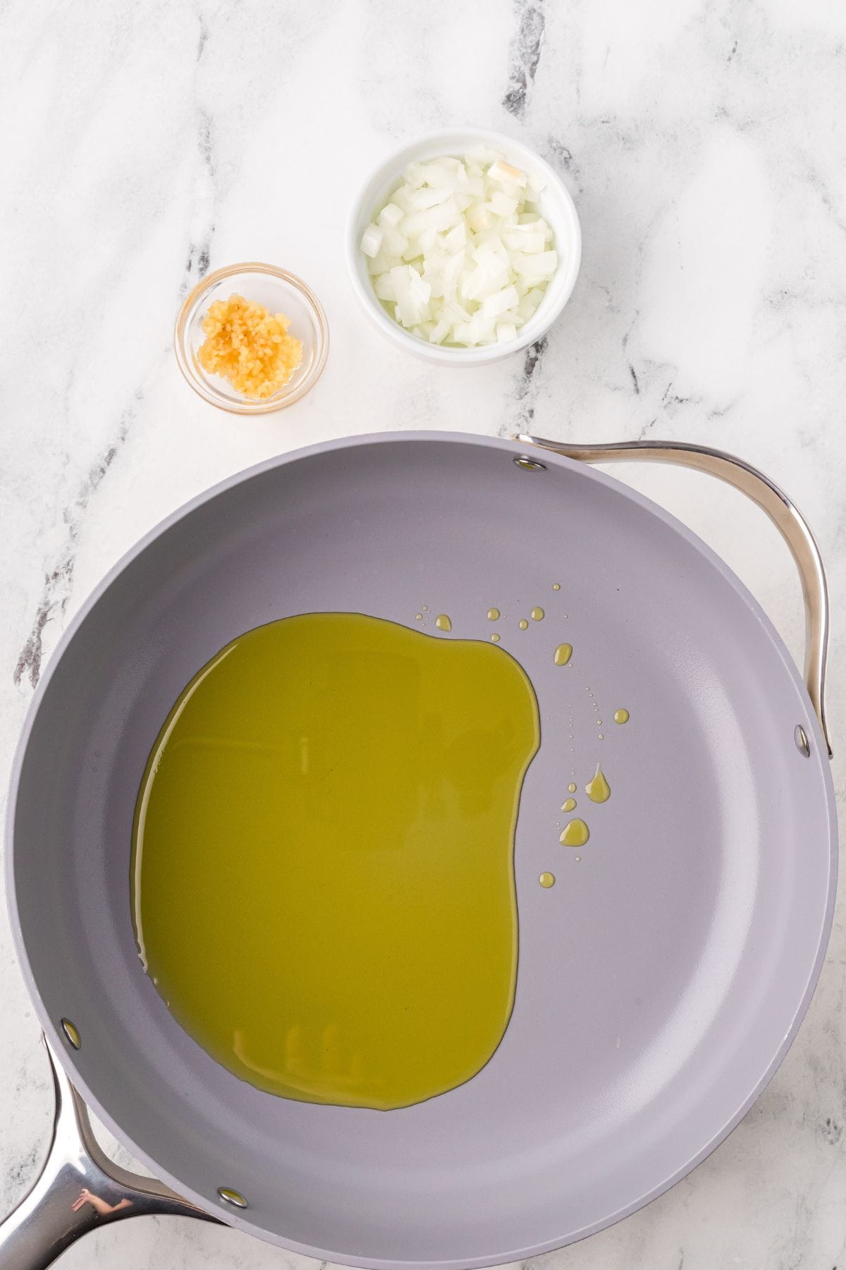 Olive oil heating in a saucepan.