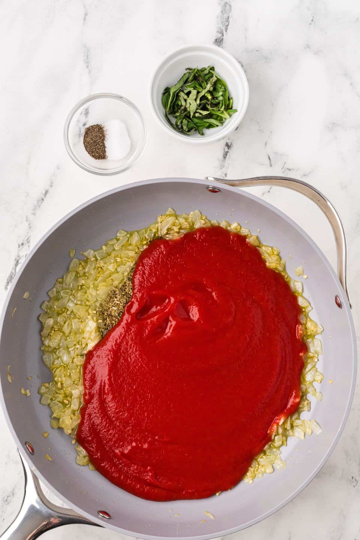 Passata added to onions and garlic in the saucepan.