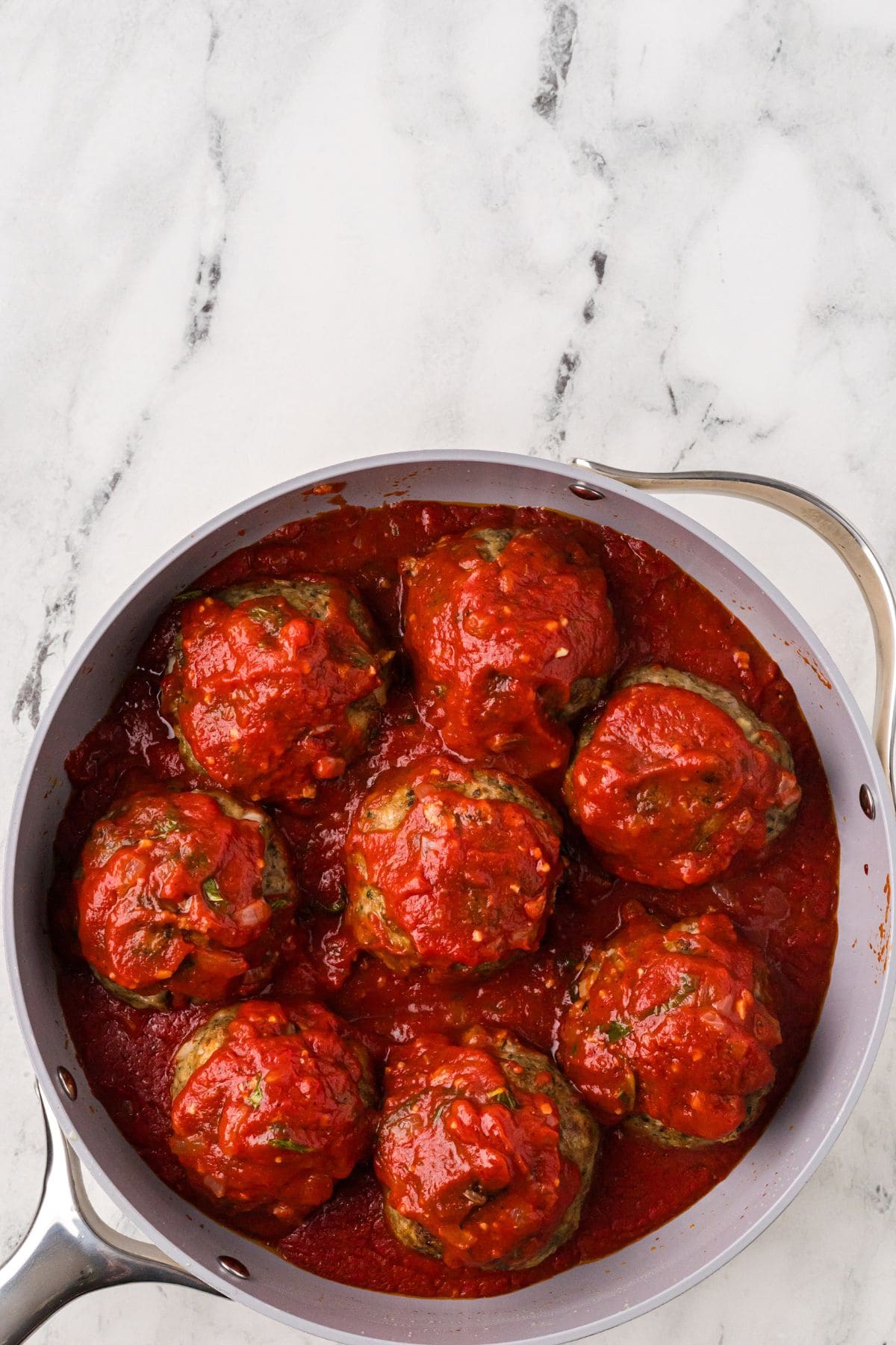 Finished meatballs and tomato sauce in the saucepan.