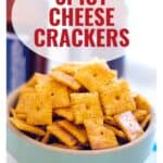 A bowl of spicy cheese crackers with bold red text that says Spicy Cheese Crackers above the bowl.