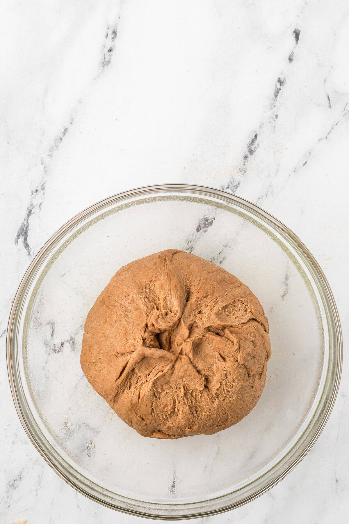 Finished dough top side down in a bowl.