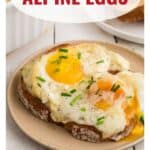 Alpine Eggs on toast, garnished with chives, on a plate with text Alpine Eggs above the dish.