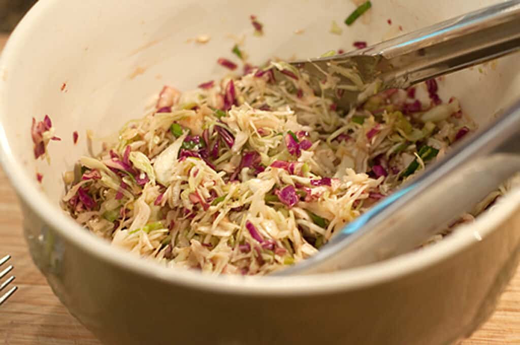 Finished coleslaw in a mixing bowl.