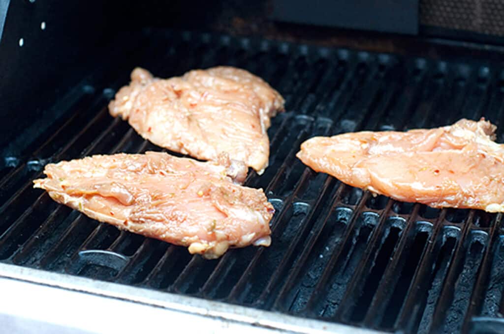Chicken cooking on a grill.