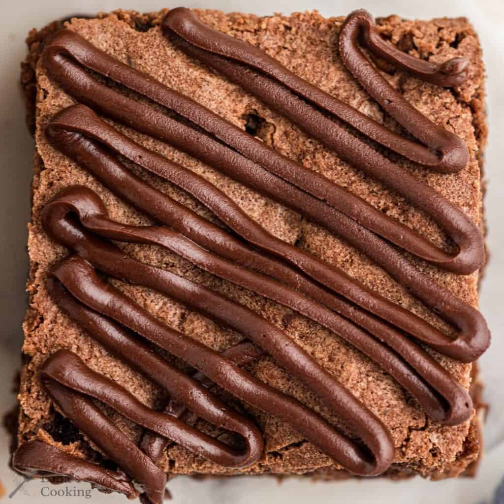 Finished brownies with chocolate drizzle on top.