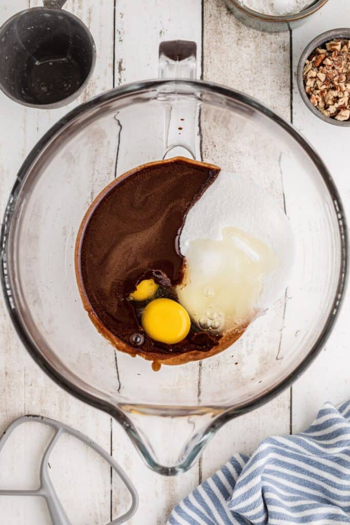 Eggs and sugar on top of the melted chocolate before being mixed together.