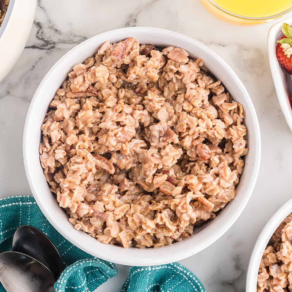 A bowl of date nut oatmeal on a marble background.