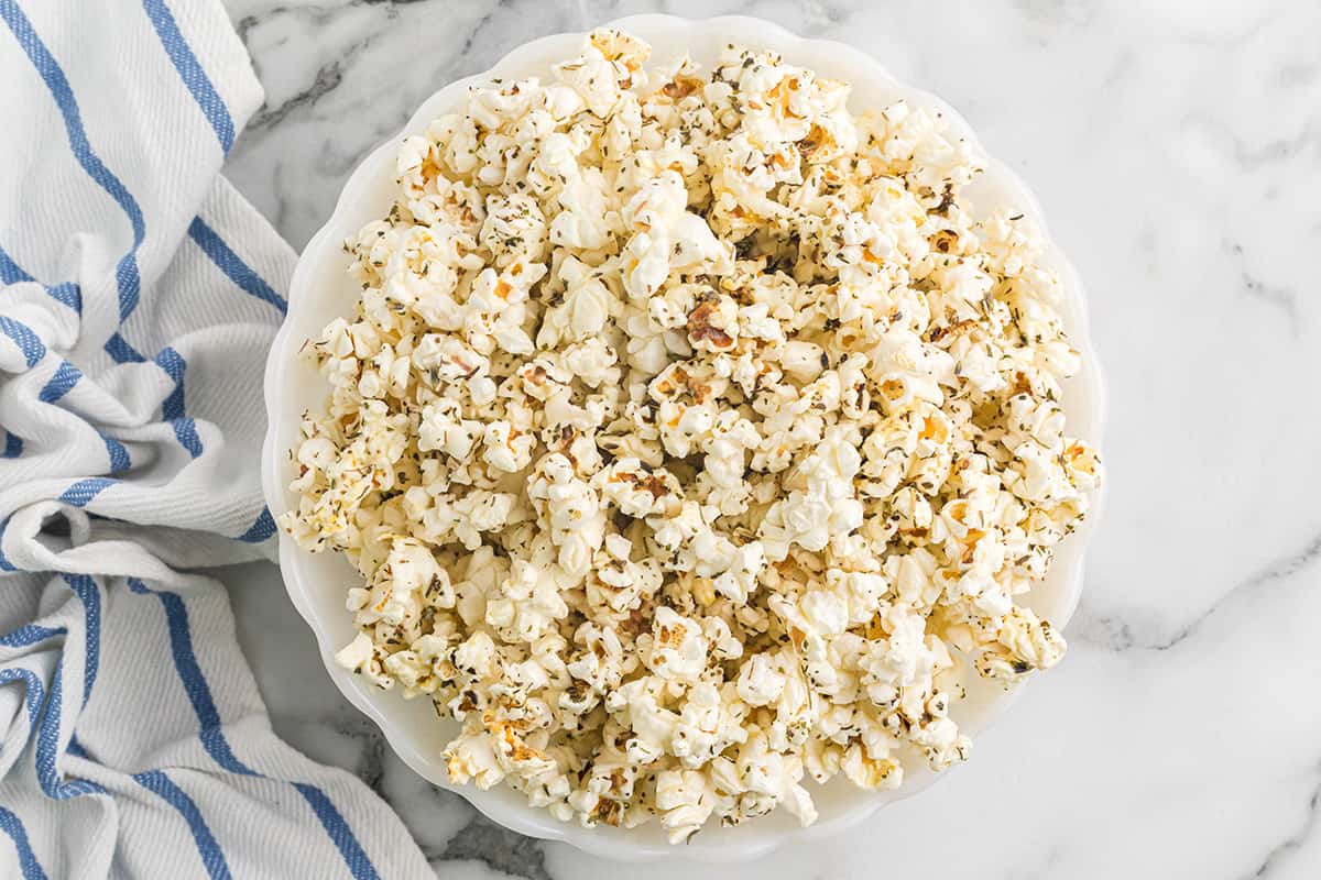 A white serving bowl filled with popcorn.