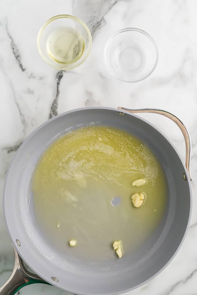 Garlic and butter cooking in a skillet.