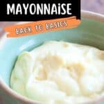 A bowl filled with homemade mayonnaise sits on a wooden surface. Text on the image reads: Learn to make homemade mayonnaise. Back to basics. www.lanascooking.com.