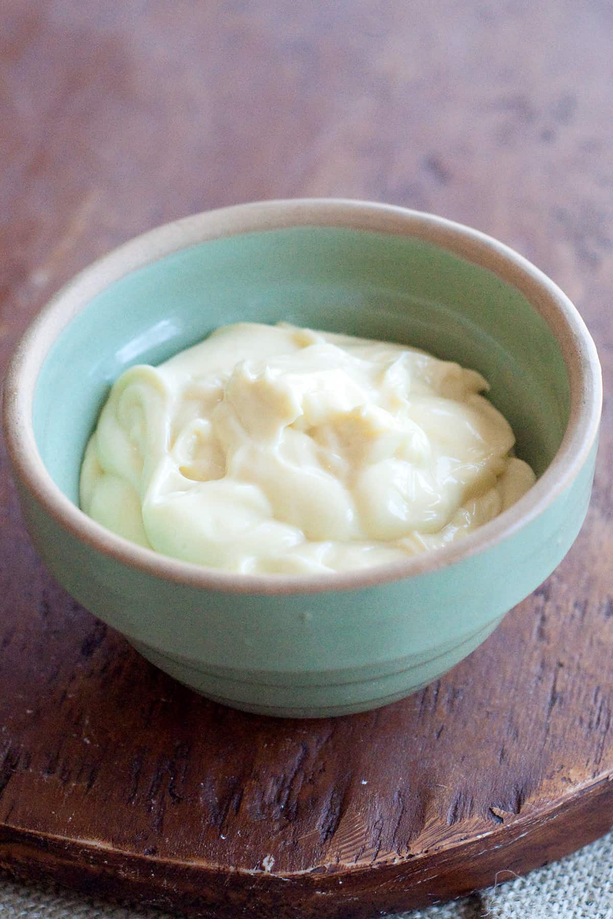 Finished homemade mayonnaise in a green vintage bowl.