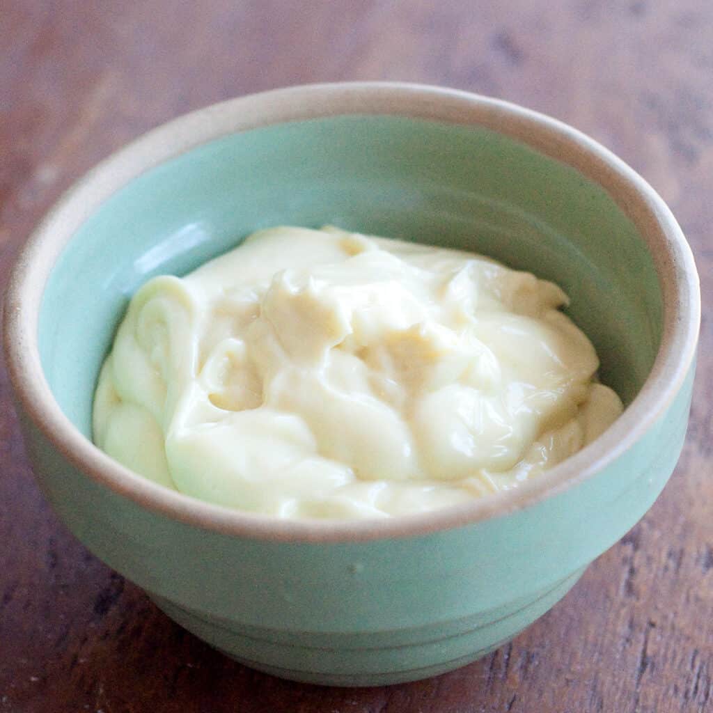 Finished homemade mayonnaise in a green vintage bowl.