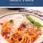 Spaghetti with tomato sauce, topped with grated cheese and fresh basil.