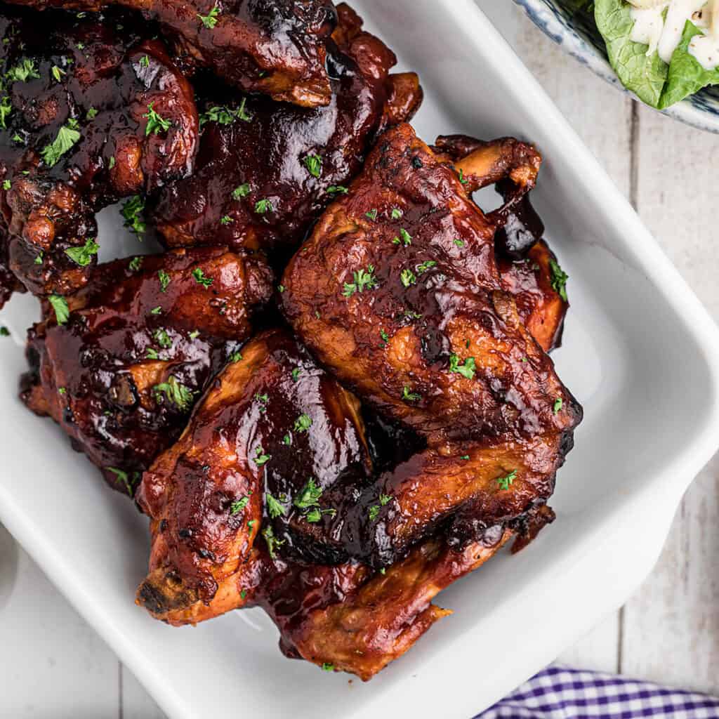 Finished chicken arranged on a white serving platter.