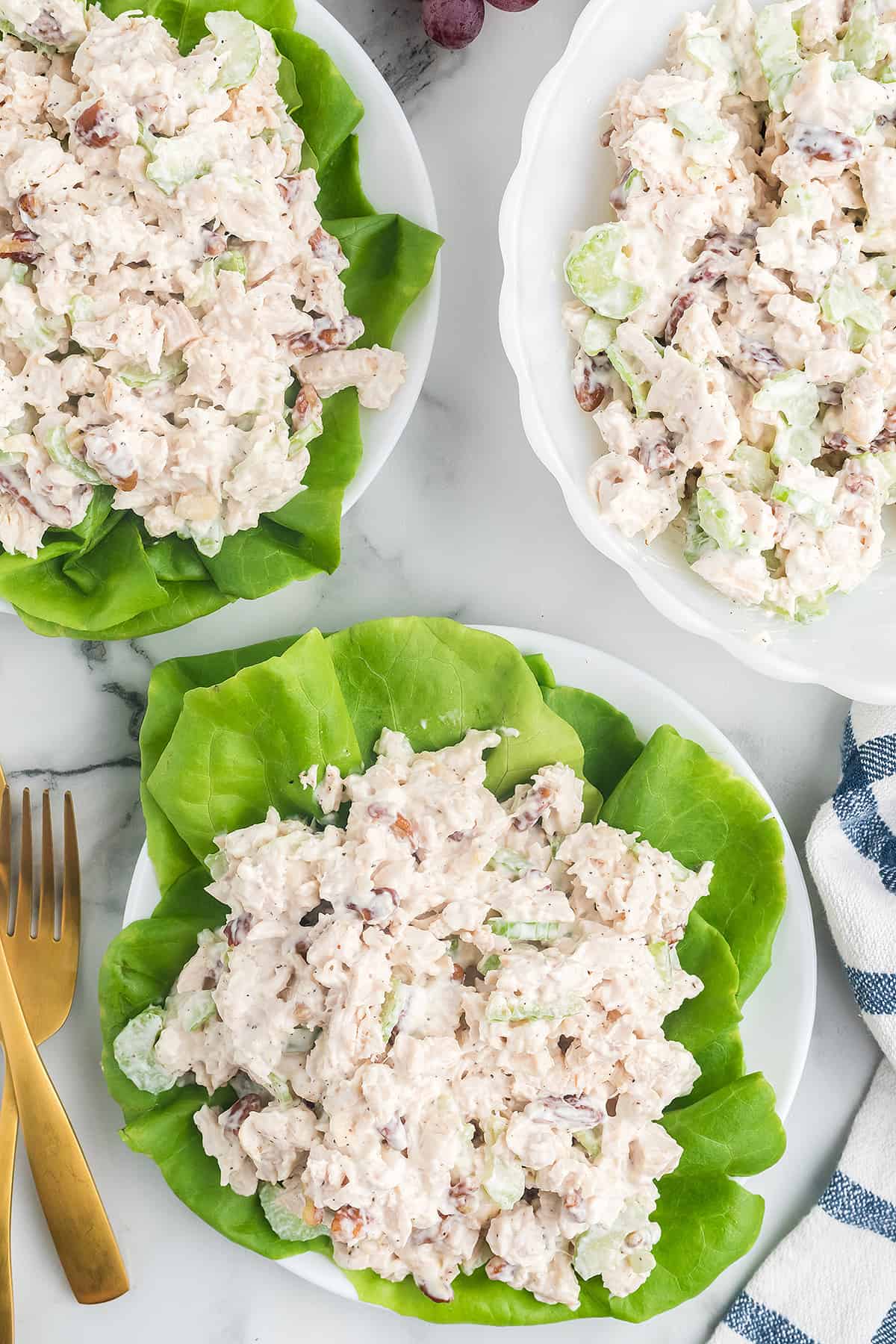 A mound of chicken salad on a lettuce lined plate.