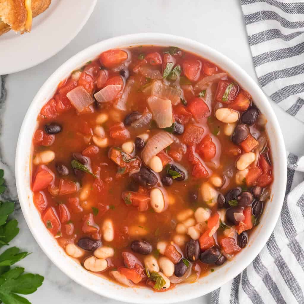 A serving of soup in a white bowl.