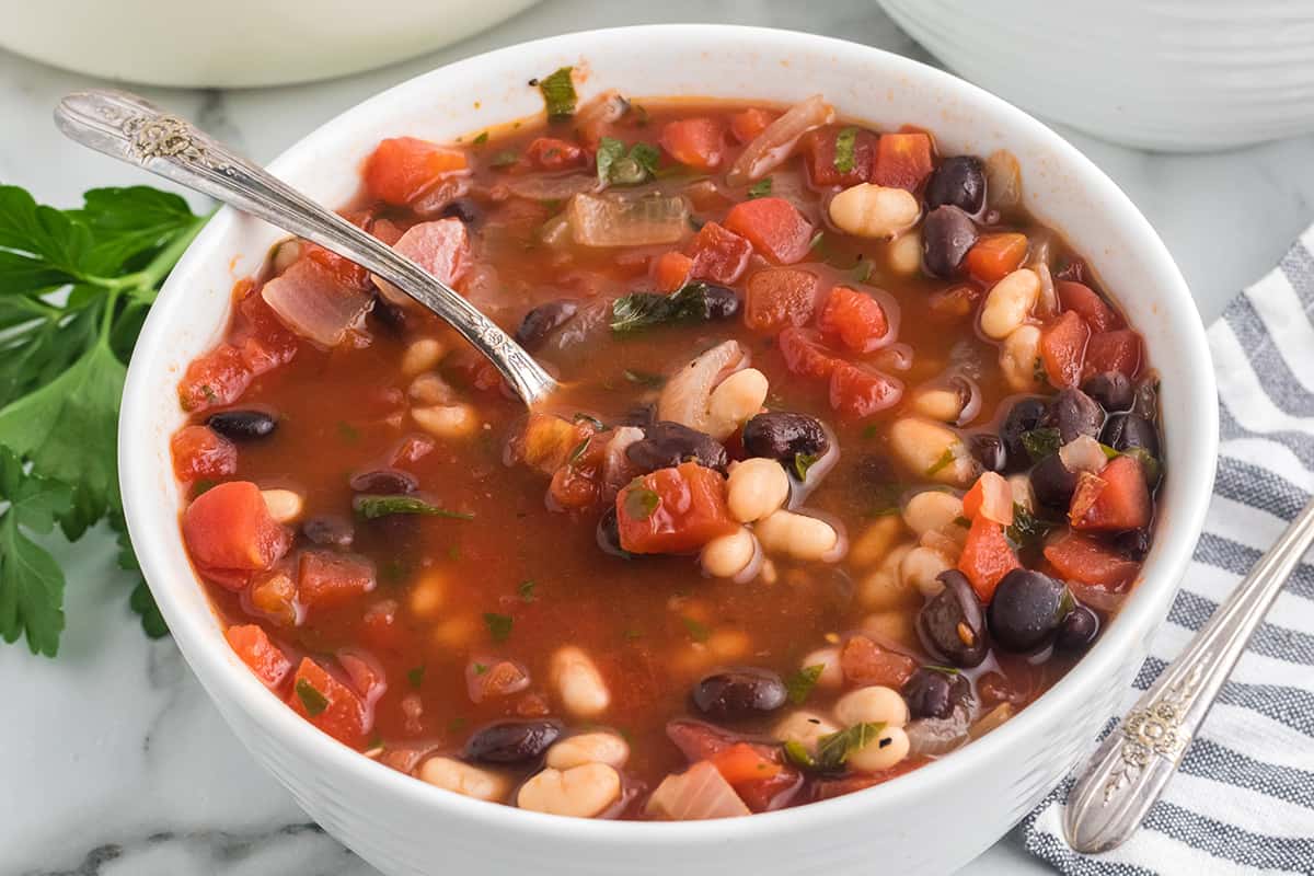 A serving of soup in a white bowl.