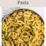 Skillet of sausage and leek pasta with peas.