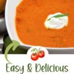 A bowl of tomato tarragon soup with a dollop of cream and a tarragon leaf garnish, next to a slice of bread. Text reads “Easy & Delicious Tomato Tarragon Soup. Get the recipe — lanascooking.com.”.