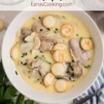 A serving of oyster stew in a white bowl.