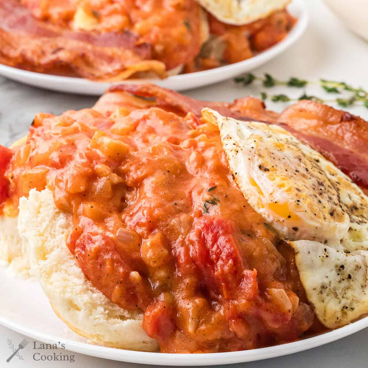 Tomato gravy over biscuits topped with a fried egg.