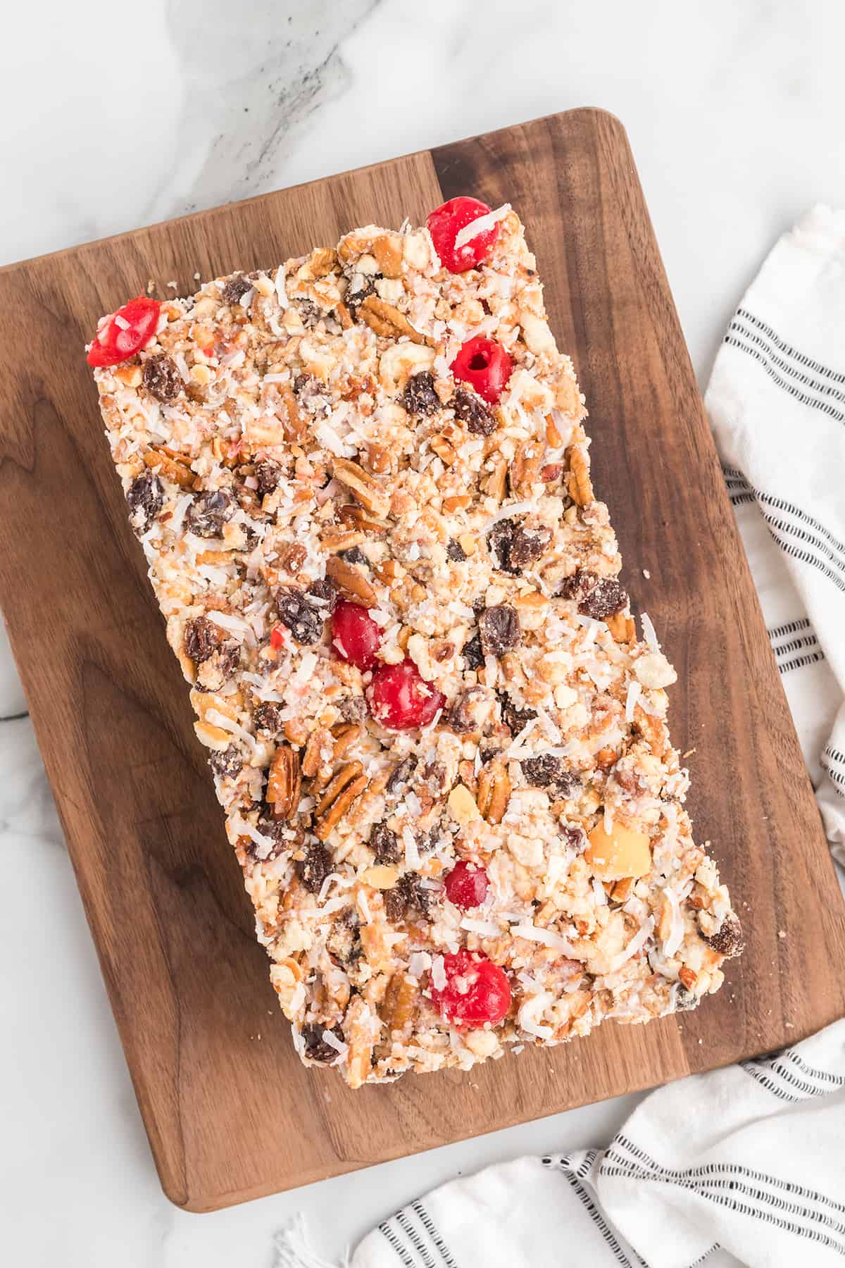 Finished no-bake fruitcake on a serving board.