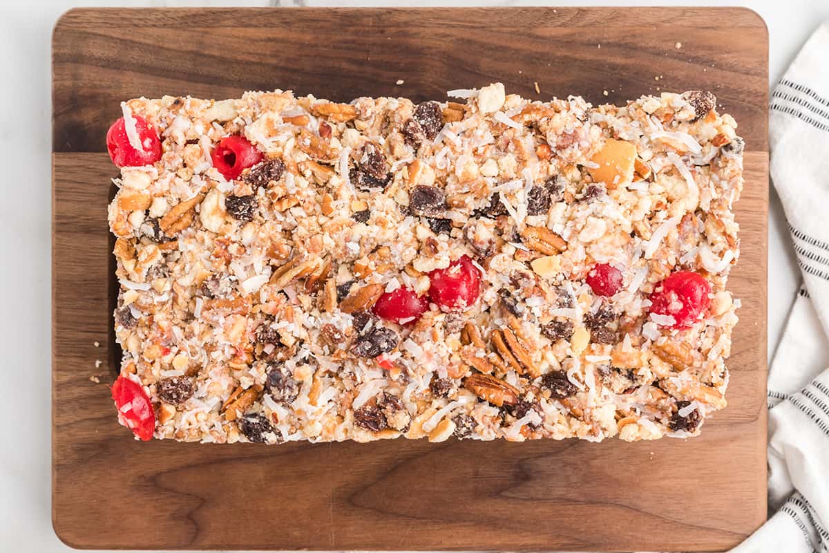 Finished no-bake fruitcake on a serving board.