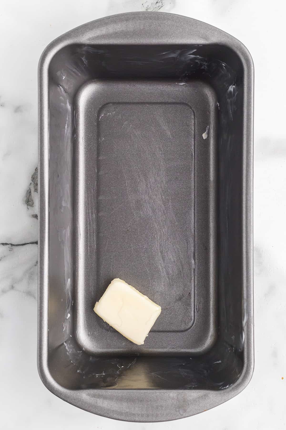 A buttered loaf pan.